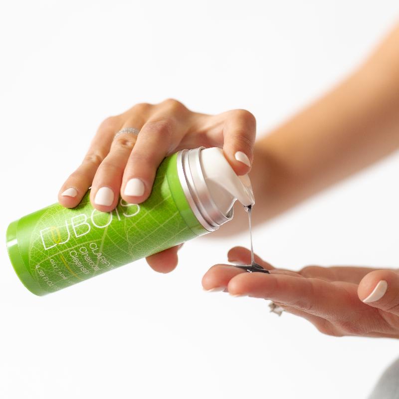 woman's hand with charcoal cleanser