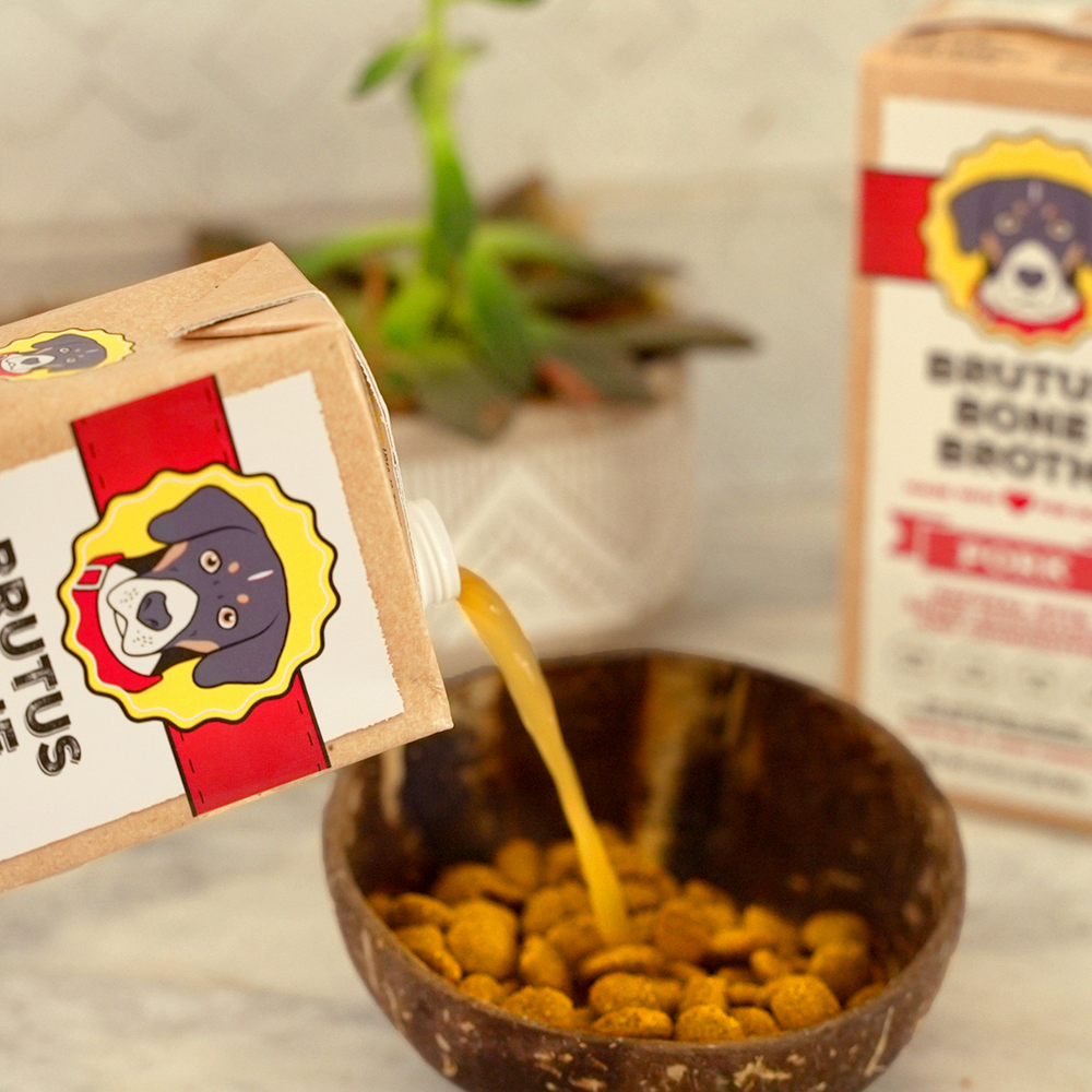 
                      
                        Pork Bone Broth being poured into a bowl of kibble
                      
                    