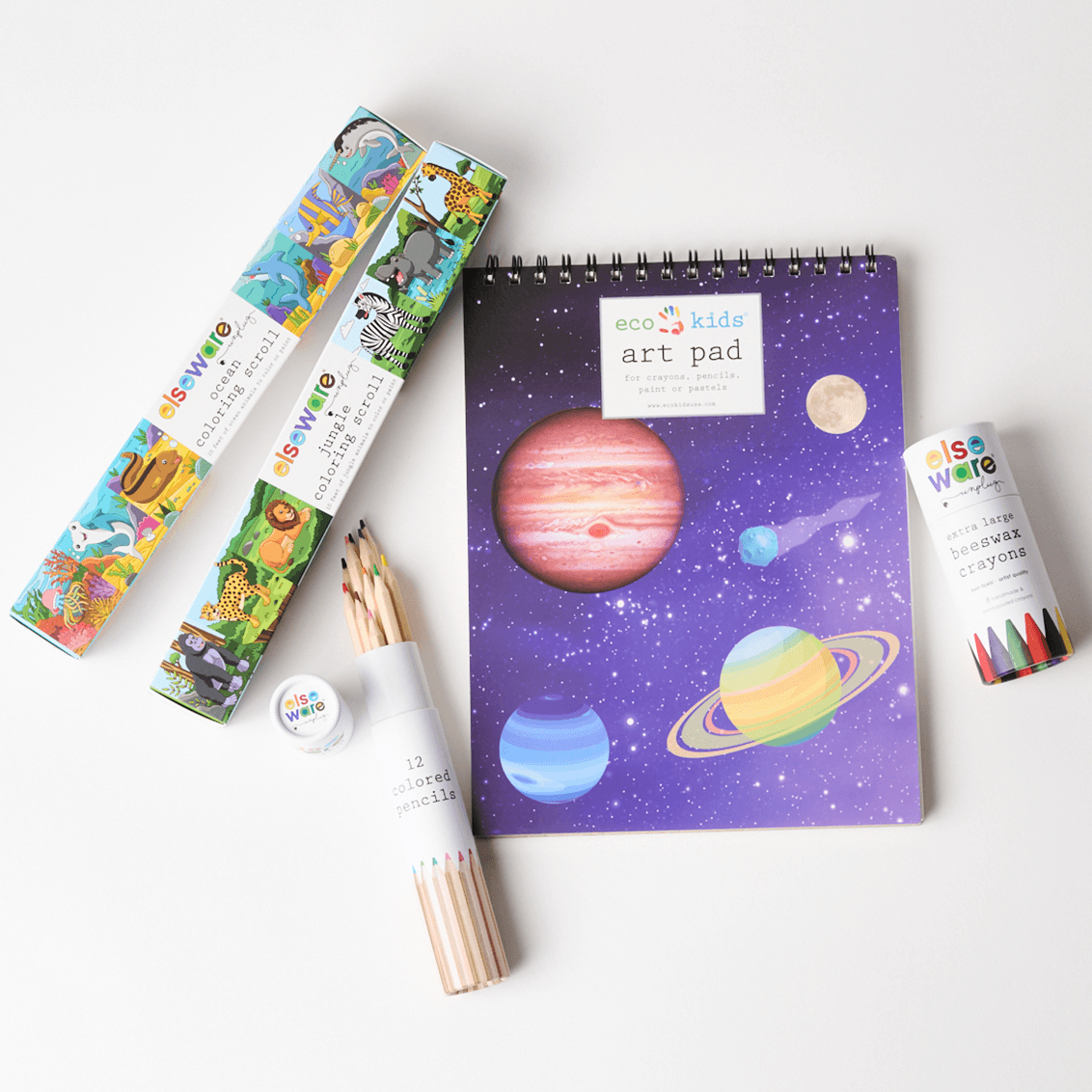 Children's art supplies including a notebook with space-themed design, colored pencils, and markers on a white background.
