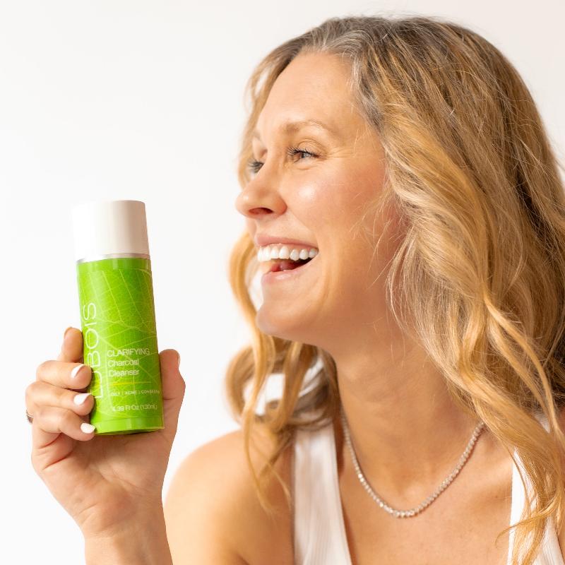 woman holding charcoal cleanser